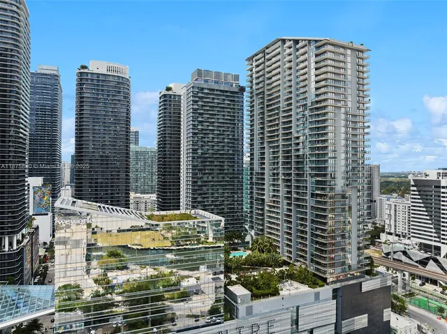 an aerial view of houses with a swimming pool