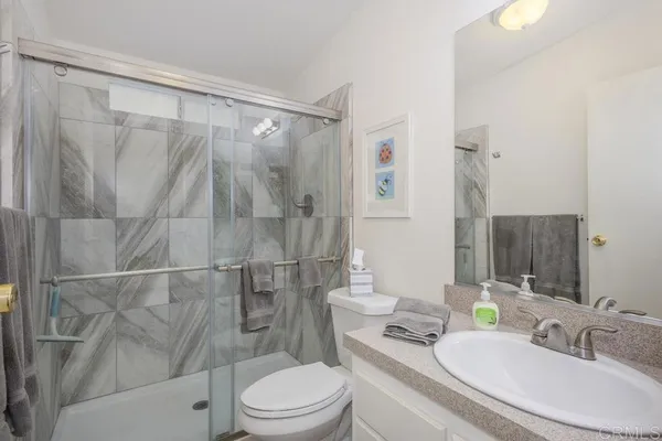 a bedroom with a bed and a mirror
