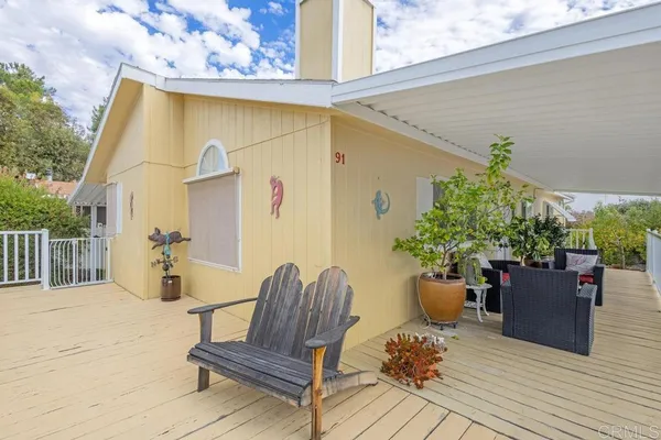 a view of a house with a wooden fence