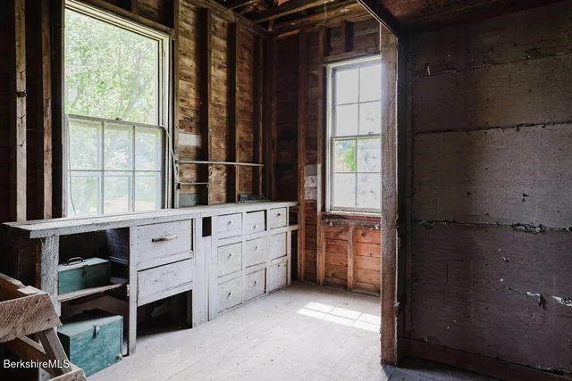 a view of a blue house with large windows
