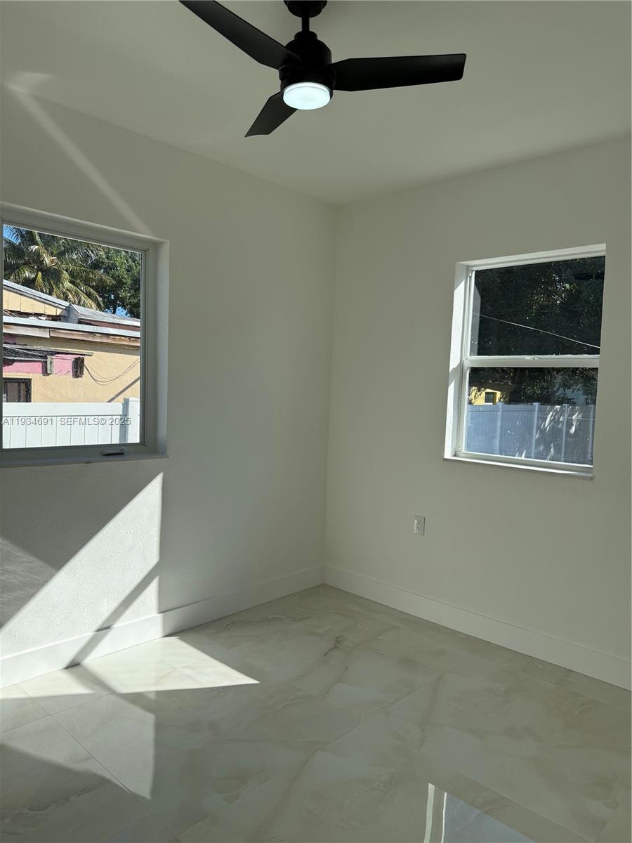 260 Northwest 119th Street Miami, FL 33168 - Photo 23 of 31 a view of a livingroom with a ceiling fan and window