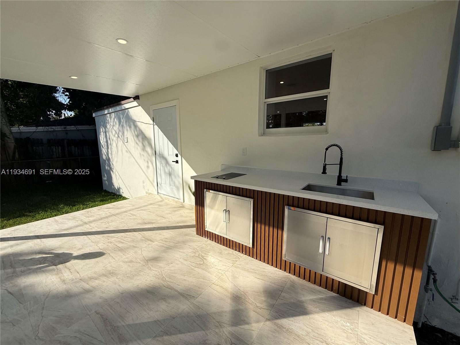 260 Northwest 119th Street Miami, FL 33168 - Photo 27 of 31 a kitchen with stainless steel appliances a sink stove and cabinets