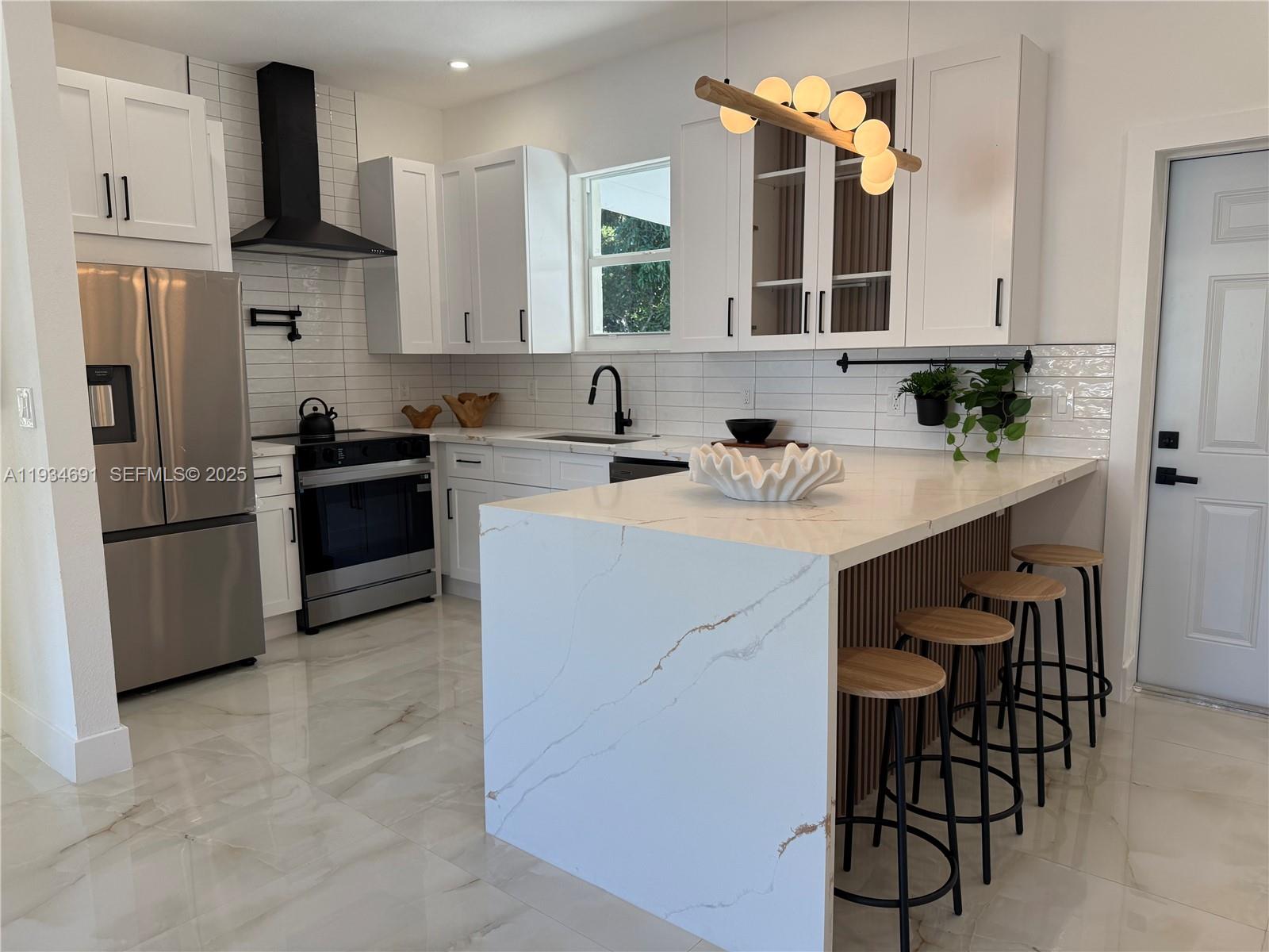 260 Northwest 119th Street Miami, FL 33168 - Photo 4 of 31 a kitchen with a sink cabinets and stainless steel appliances