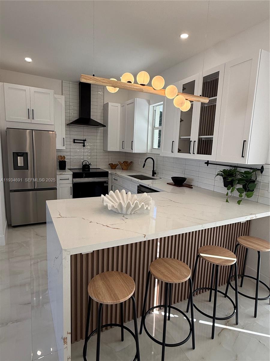 260 Northwest 119th Street Miami, FL 33168 - Photo 6 of 31 a kitchen with stainless steel appliances granite countertop a sink table and chairs