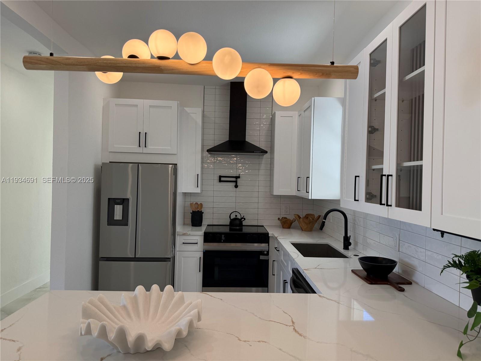 260 Northwest 119th Street Miami, FL 33168 - Photo 7 of 31 a kitchen with a refrigerator and a sink