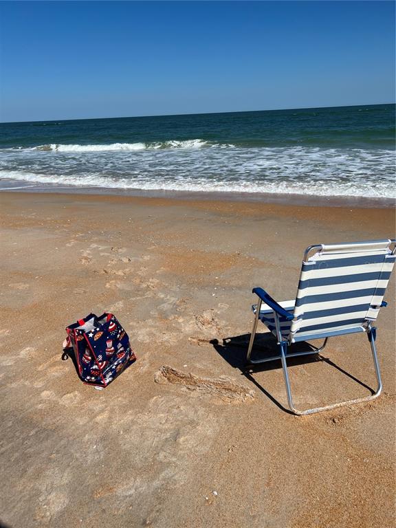 108 Coronado Road Flagler Beach, FL 32136 - Photo 11 of 14 a room with wooden floor and table