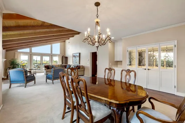 a view of a dining room with furniture and chandelier