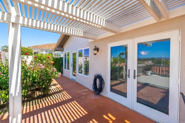a view of balcony with furniture and umbrella