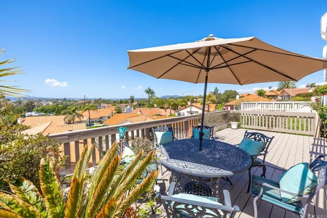 an aerial view of a house with a yard and lake view