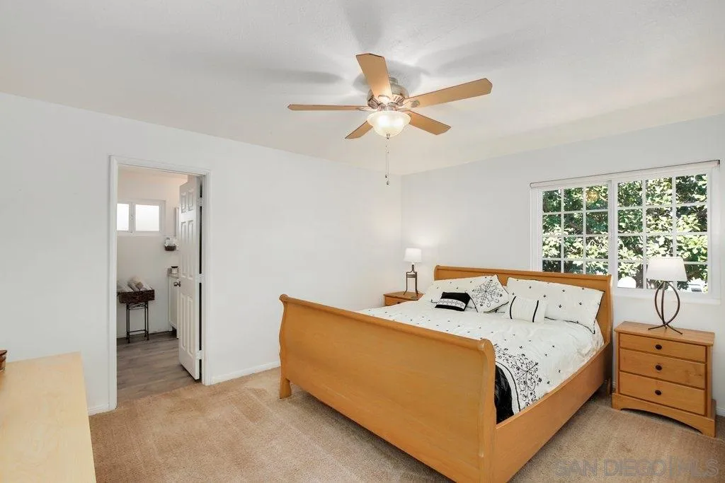 2809 Reed Road Escondido, CA 92027 - Photo 11 of 25 a bedroom with a bed and large windows
