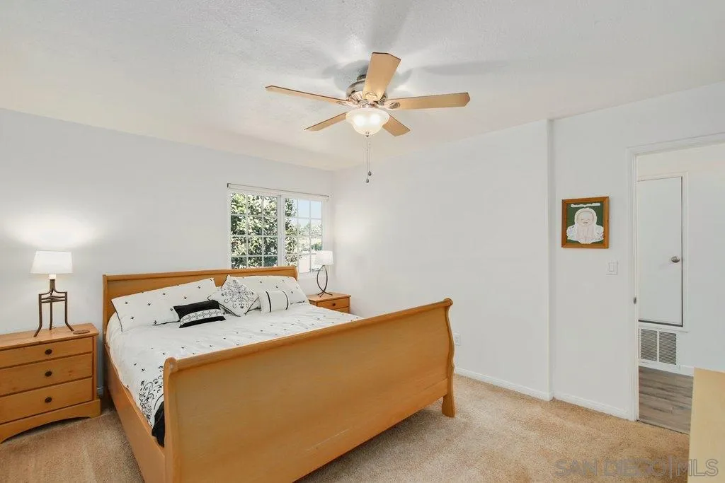 2809 Reed Road Escondido, CA 92027 - Photo 12 of 25 a bedroom with a bed and a chandelier