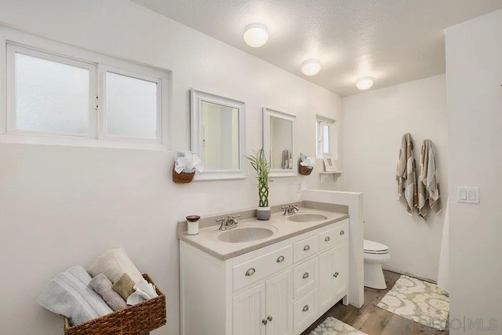 2809 Reed Road Escondido, CA 92027 - Photo 13 of 25 a bathroom with a sink toilet and mirror