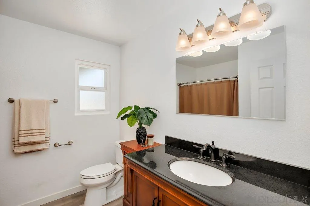 2809 Reed Road Escondido, CA 92027 - Photo 16 of 25 a bathroom with a sink a toilet and a mirror