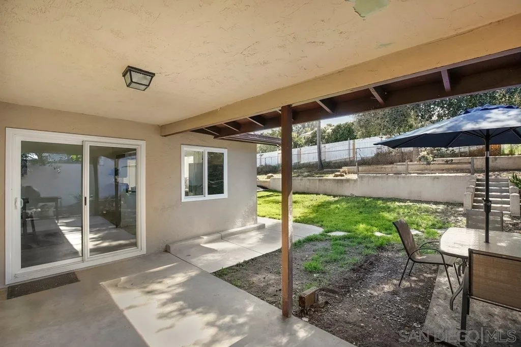 2809 Reed Road Escondido, CA 92027 - Photo 23 of 25 a view of a patio with table and chairs under an umbrella