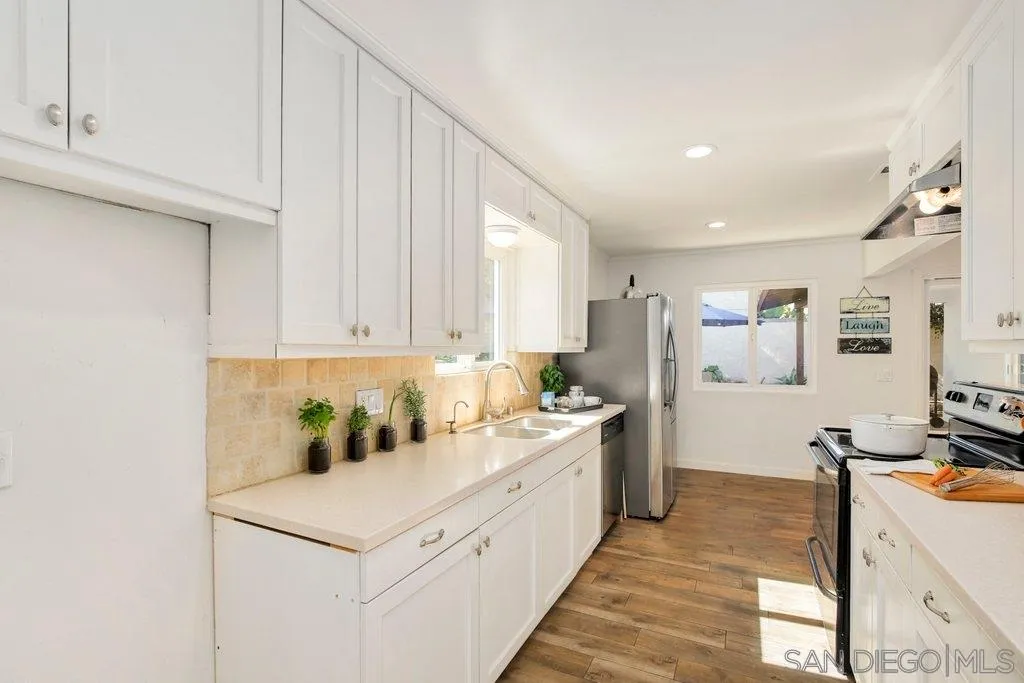2809 Reed Road Escondido, CA 92027 - Photo 5 of 25 a kitchen with a sink stove and cabinets