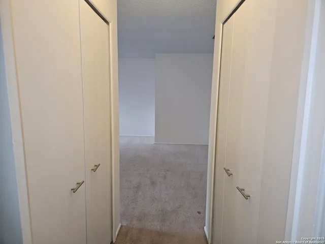 a view of an empty room and a window