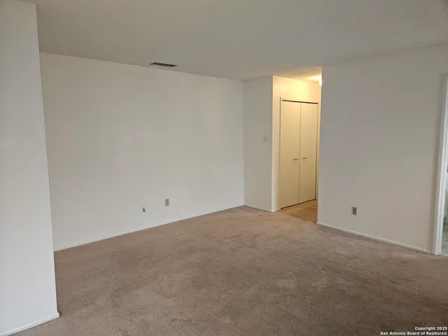 a view of an empty room and a window