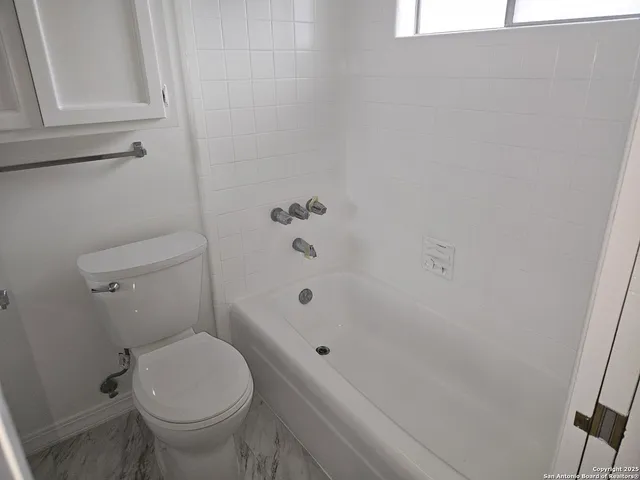 a bathroom with a sink and cabinets
