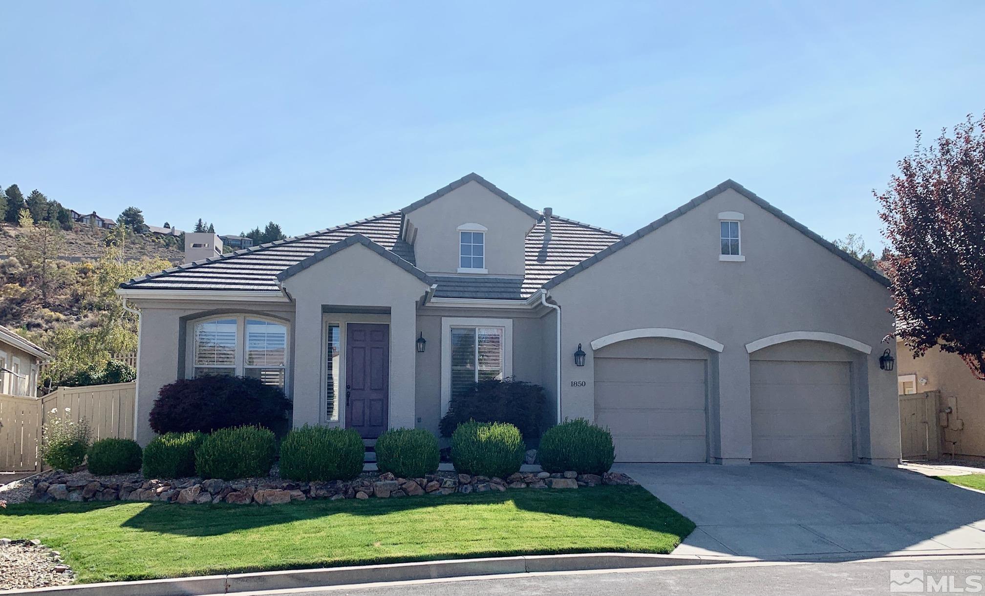1850 Hunter Creek Road Reno, NV 89519 - Photo 1 of 38 a front view of a house with garden