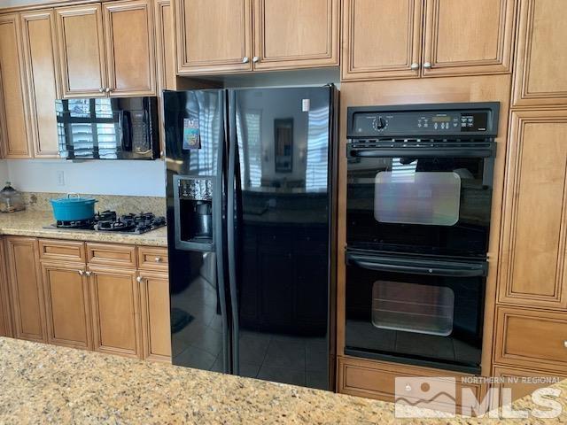 1850 Hunter Creek Road Reno, NV 89519 - Photo 21 of 38 a kitchen with stainless steel appliances granite countertop a stove and a microwave