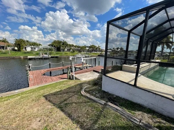 a view of a lake with couches chairs
