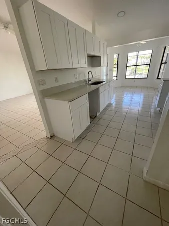a kitchen with stainless steel appliances a sink a stove a microwave a counter top space and cabinets