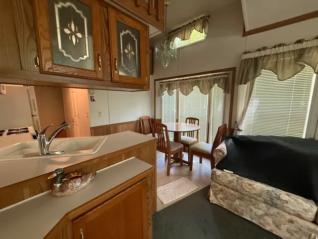 a kitchen with a table chairs and a refrigerator