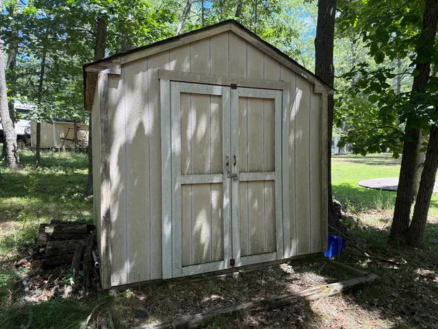 a backyard of a house with barbeque oven