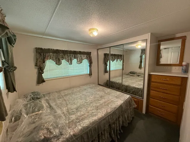 a bedroom with a bed and a walk in closet