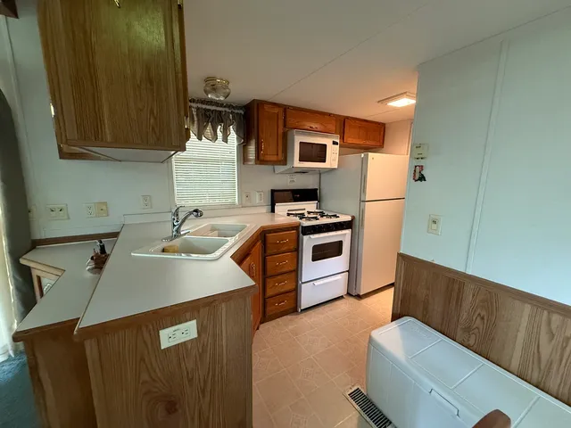 a kitchen with a sink a stove and a refrigerator