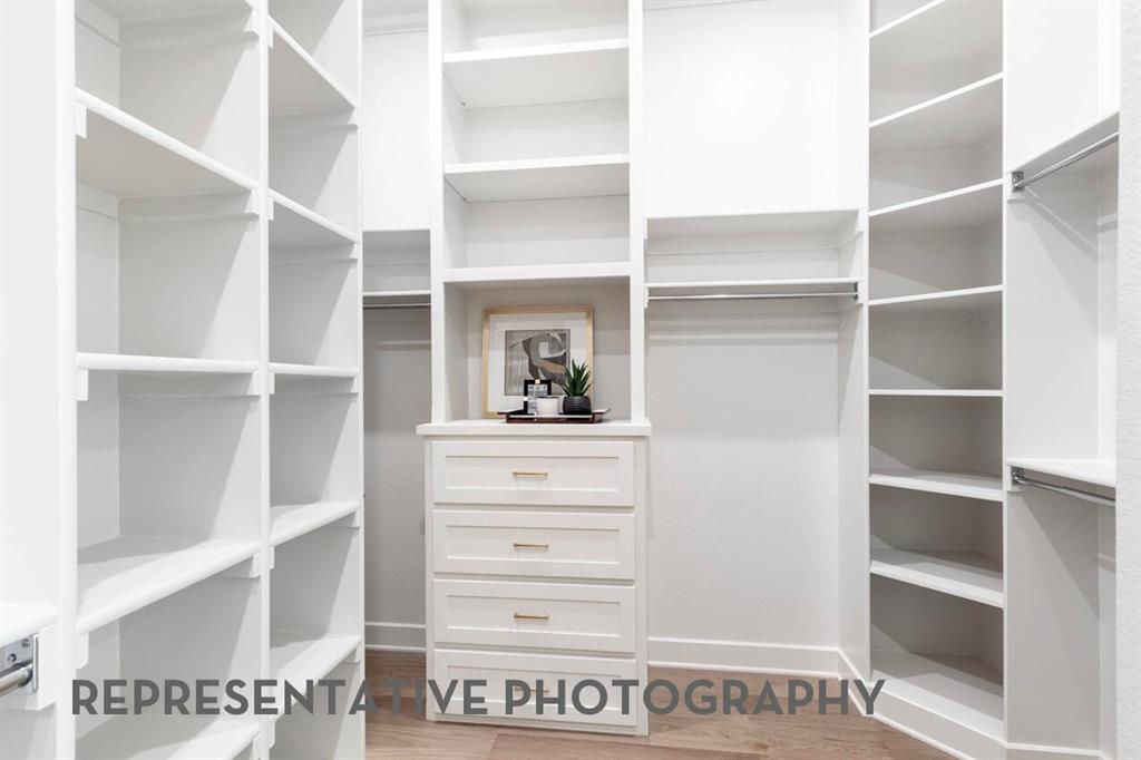 3808 Meander Way Prosper, TX 75078 - Photo 25 of 40 a view of walk in closet with empty racks