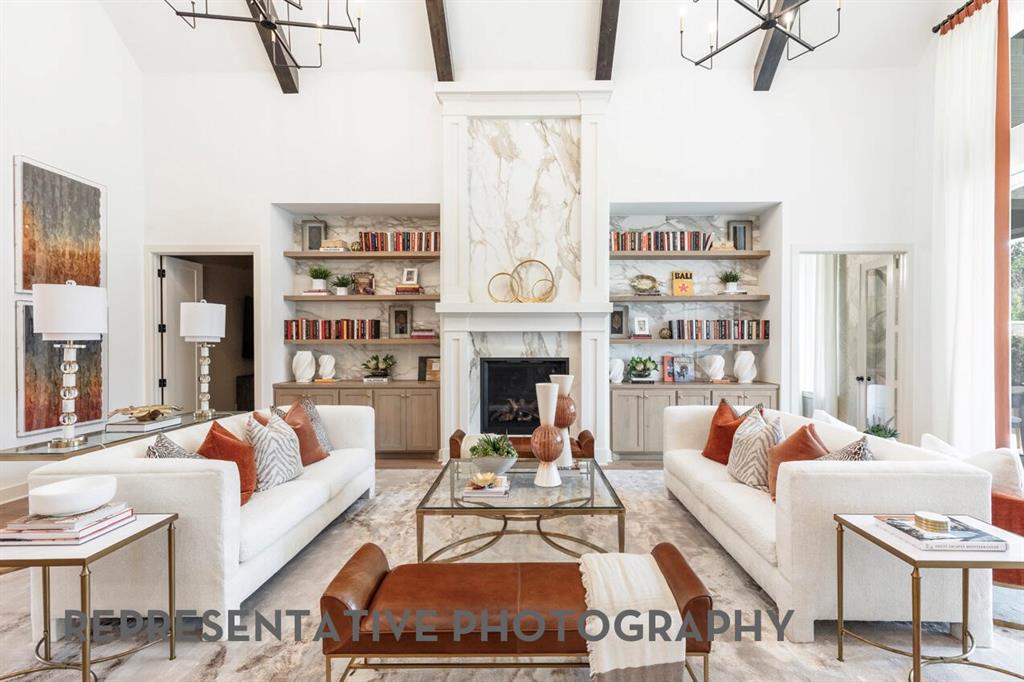3808 Meander Way Prosper, TX 75078 - Photo 3 of 40 a living room with furniture a rug a fireplace and a large window