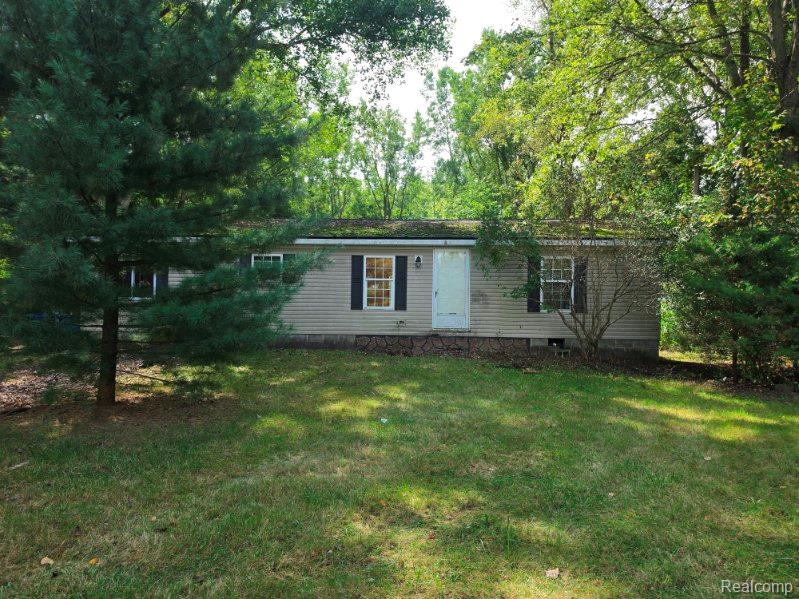 3897 Swaffer Road Millington, MI 48746 - Photo 1 of 16 Single-story residence featuring light-toned siding, dark shutters, and a white entry door
