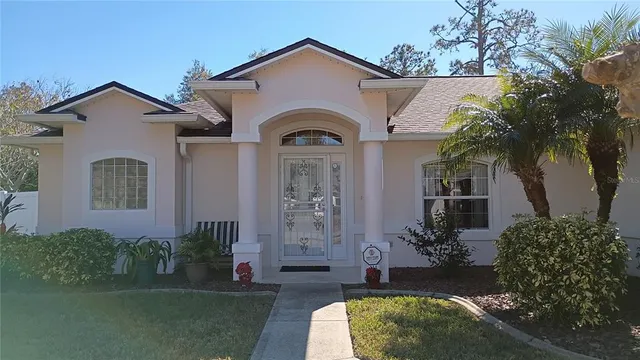 a dining room with furniture a chandelier and wooden floor