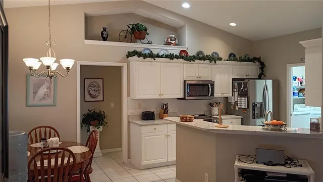 a en suite bathroom with a granite countertop sink and a mirror
