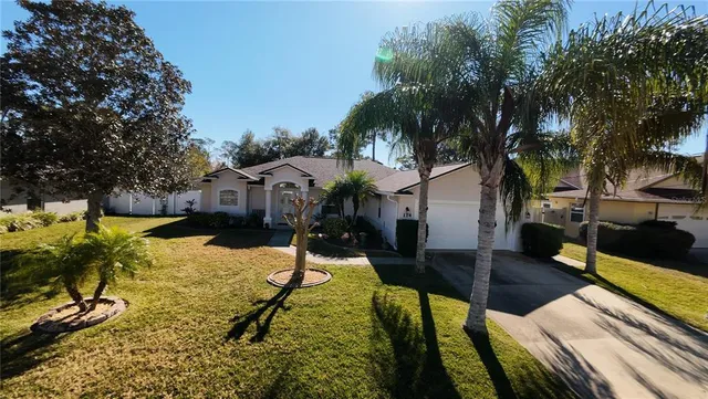 a front view of house with yard and green space