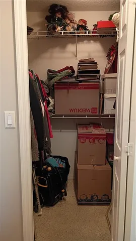 a bedroom with bed and paintings on the wall