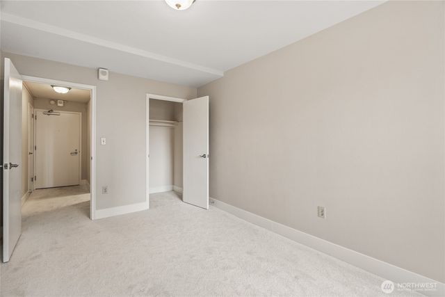 an empty room with closet area