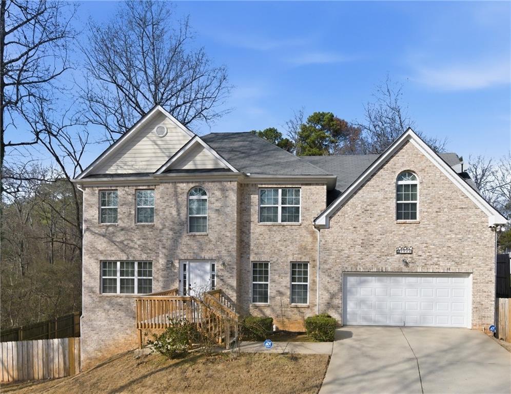 a view of a white house next to a yard