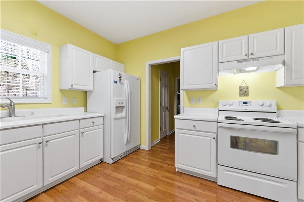 5980 Giles Road Lithonia, GA 30058 - Photo 11 of 38 a kitchen with cabinets appliances and a window