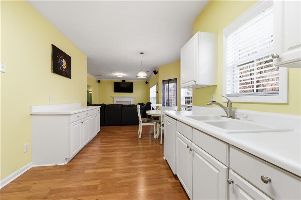 5980 Giles Road Lithonia, GA 30058 - Photo 13 of 38 a large kitchen with stainless steel appliances kitchen island granite countertop a sink and cabinets