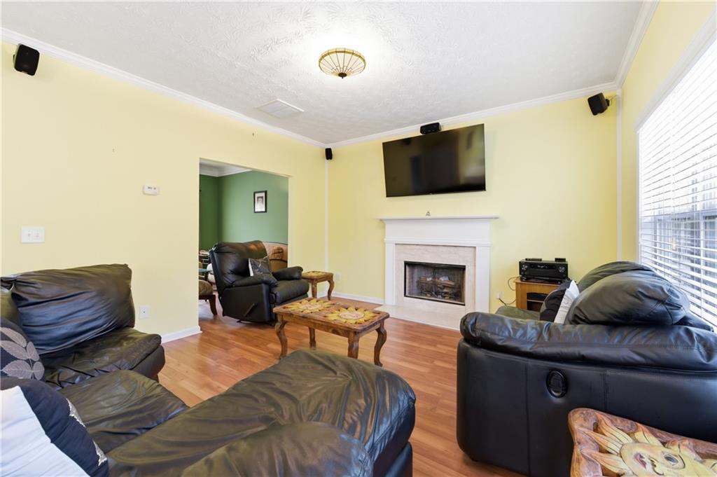 5980 Giles Road Lithonia, GA 30058 - Photo 16 of 38 a living room with furniture a flat screen tv and a fireplace