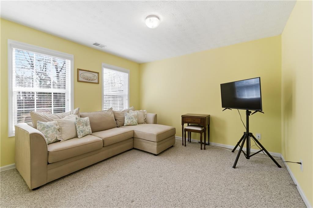 5980 Giles Road Lithonia, GA 30058 - Photo 20 of 38 a living room with furniture and a flat screen tv
