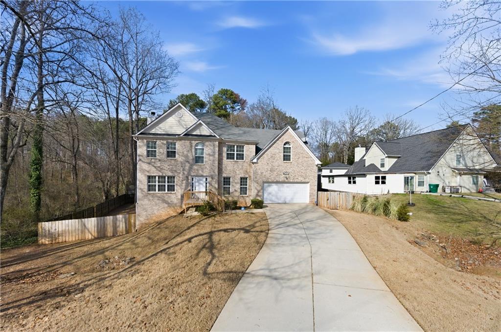 5980 Giles Road Lithonia, GA 30058 - Photo 2 of 38 a view of a house with a yard