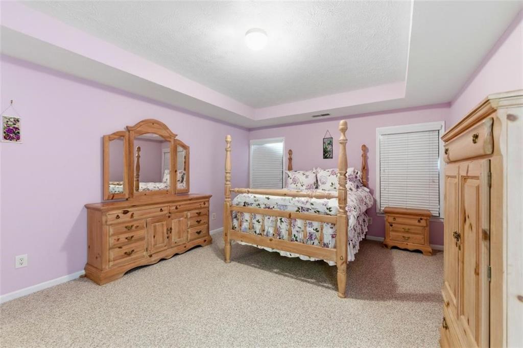 5980 Giles Road Lithonia, GA 30058 - Photo 24 of 38 a bedroom with a bed dresser and a window