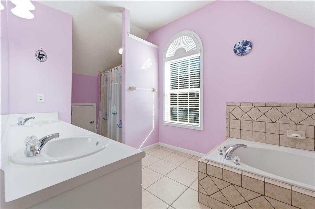 5980 Giles Road Lithonia, GA 30058 - Photo 27 of 38 a bathroom with a tub sink and mirror