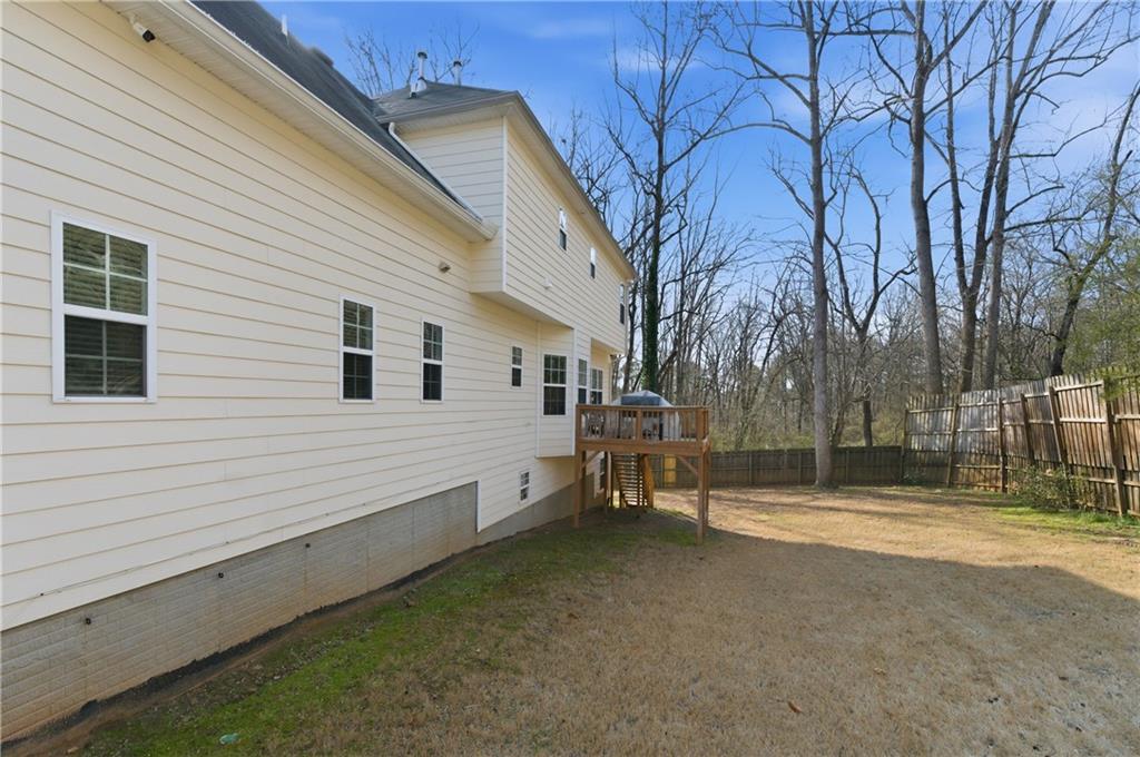 5980 Giles Road Lithonia, GA 30058 - Photo 4 of 38 a view of a house with backyard and trees
