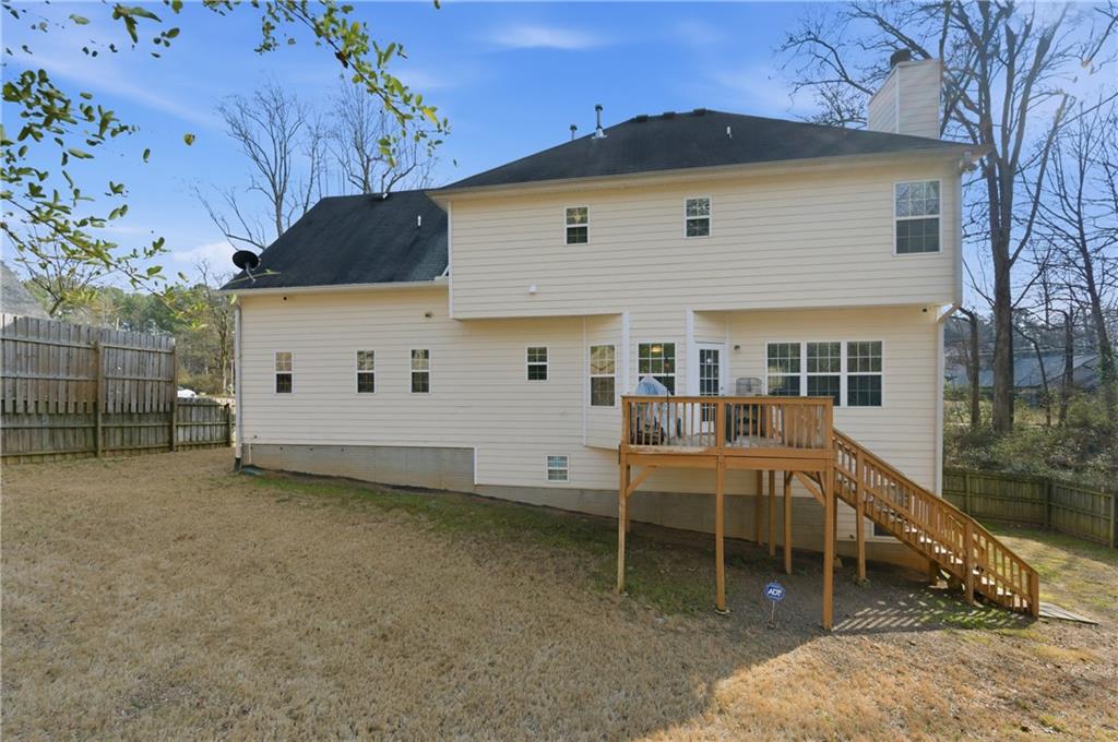 5980 Giles Road Lithonia, GA 30058 - Photo 5 of 38 a view of a house with a yard