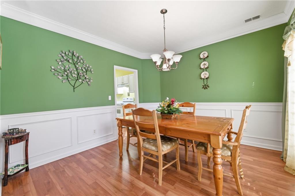5980 Giles Road Lithonia, GA 30058 - Photo 9 of 38 a view of a dining room with furniture and wooden floor
