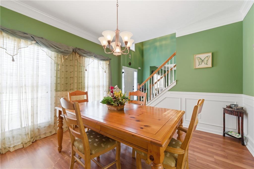 5980 Giles Road Lithonia, GA 30058 - Photo 10 of 38 a view of a dining room with furniture window and wooden floor